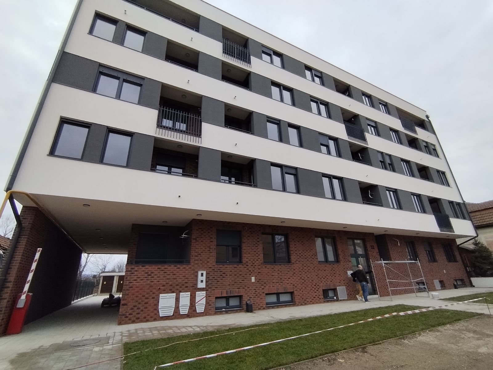 Main entrance of the Jerneja Kopitara residential development in Novi Sad, Serbia with brick-clad ground floor